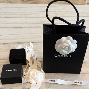 Chanel Black Bag with White Camellia Accent, Jewelry Box, Ribbon, and Flower